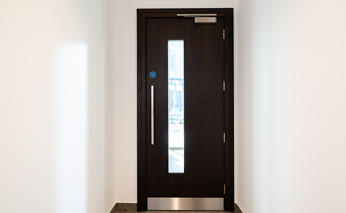 Black timber fire door with full lenth vision panel_stainless steel hardware_commercial building_education building_sports facility