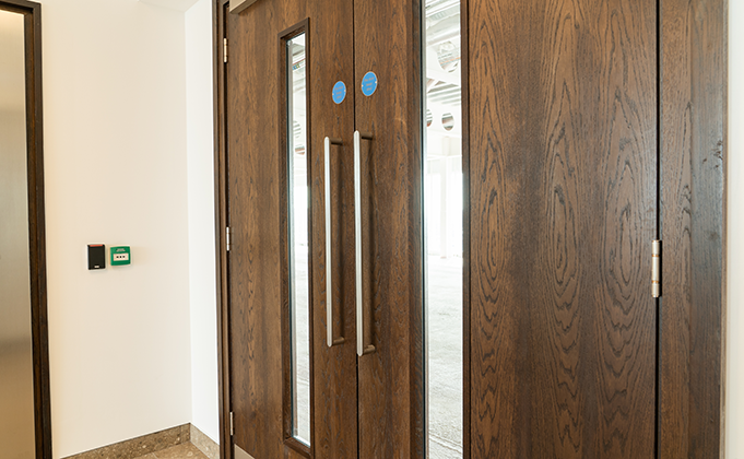 Double timber door_Walnut veneer_full length vision panels_fire doors_pull handles_commercial building