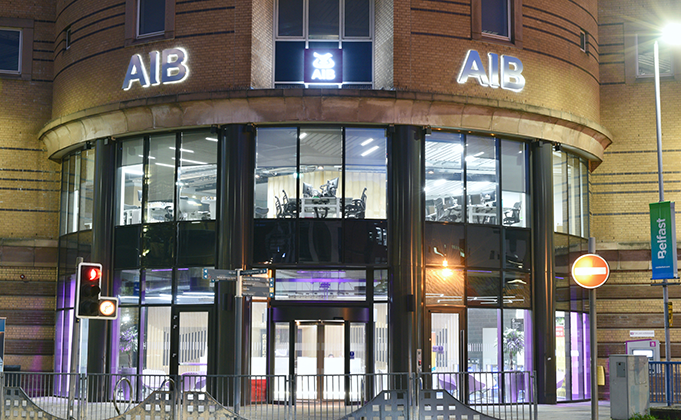 Front of building with glass curved wall and automatic revolving door_Entrance to AIB Headquarters Belfast