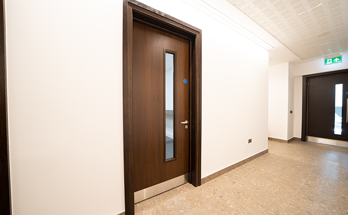 Timber fire door with vision panel_stainless steel hardware_corridor door_matching timber frame_commercial building_sports facility_education building